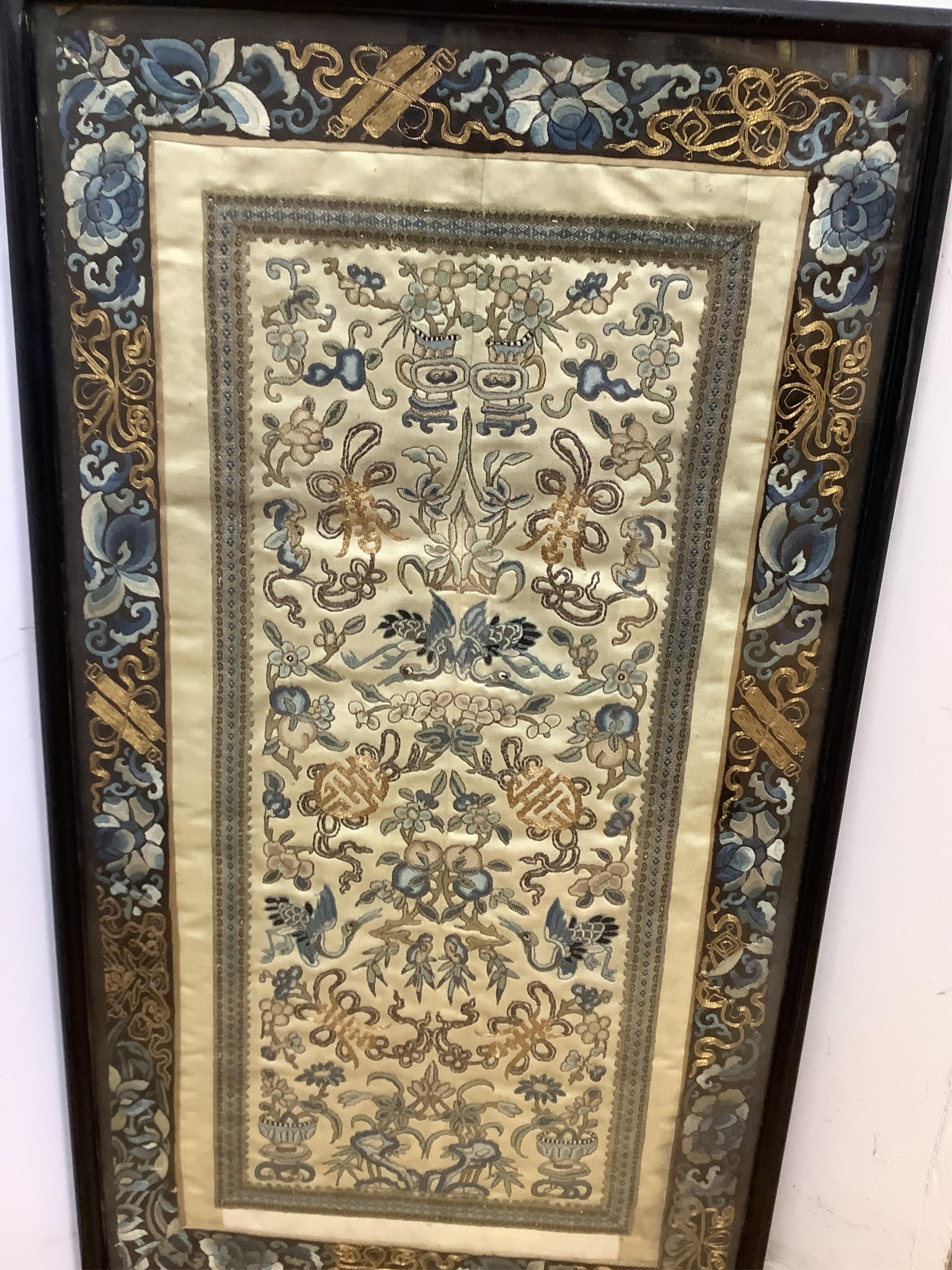Two pairs of 19th century Chinese, Peking knot, silk embroidered sleeve bands. Worked on cream silk. Both embroidered mostly in blues and gilt thread, in flower, bird and auspicious motifs, both bordered with black silk